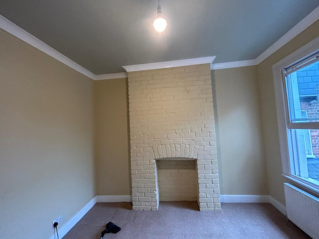 Room with white brick fireplace